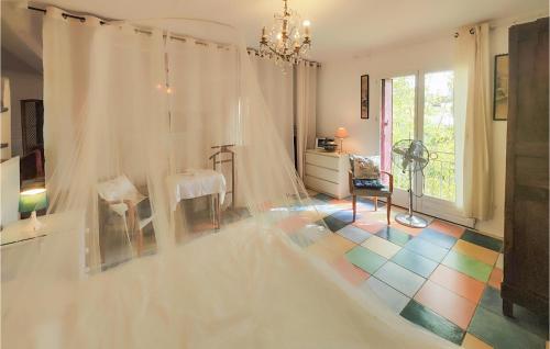 a room with a wedding dress and a colorful floor at Awesome Apartment In Puissalicon With Wifi in Puissalicon