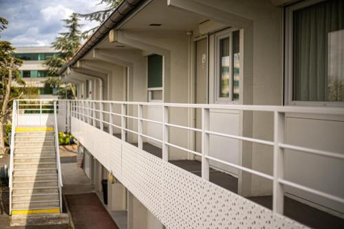 a balcony of a building with white railing at Campanile Toulouse - Blagnac Aéroport in Blagnac