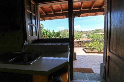 a kitchen with a sink and a window with a view at Countryside Views House Teror in Teror
