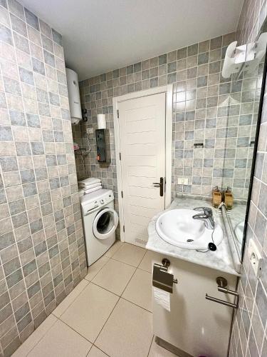 a bathroom with a sink and a washing machine at COSTA AZUL APARTMENTS -1A in Puerto de Mogán