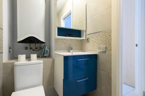 a bathroom with a blue cabinet and a sink at Canteras Suites in Las Palmas de Gran Canaria