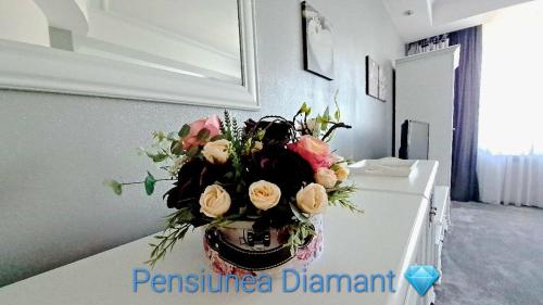a bouquet of flowers sitting on top of a table at Pensiunea Diamant in Ghimbav