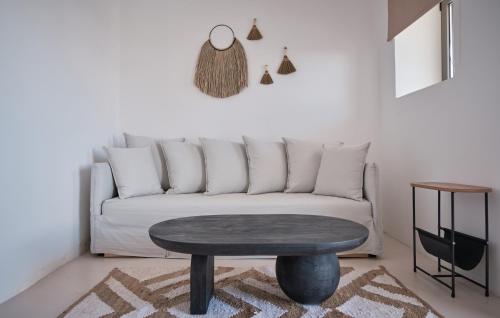 a living room with a couch and a table at Eden Kythira in Dhiakofti