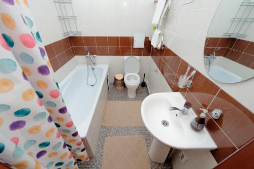 a bathroom with a sink and a toilet and a tub at Aparthotel Almarent in Almaty