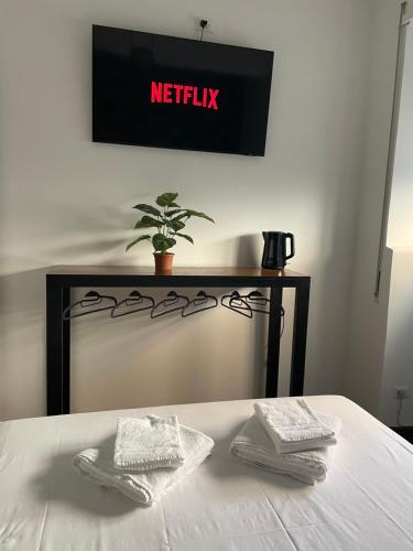 a bed with two folded towels on top of it at civico settee in Rome