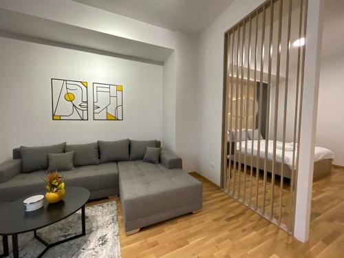 a living room with a couch and a table at Elite Central Suites in Skopje