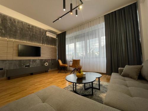 a living room with a couch and a table at Elite Central Suites in Skopje