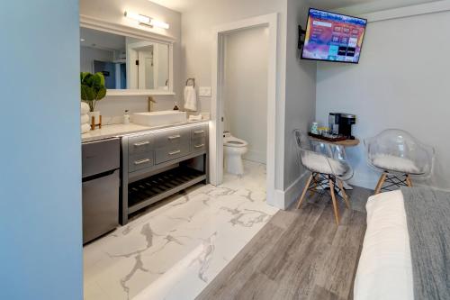 a bathroom with a sink and a toilet and a vanity with a mirror at Eagle’s Landing Lodge in Custer
