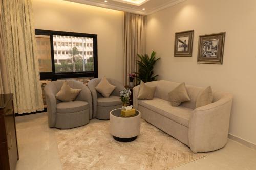 a living room with two couches and two chairs at Burj Al Hayat Furnished Suites - Al Malaz in Riyadh