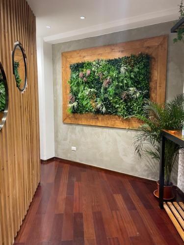 a hallway with a wall with a plant on it at civico settee in Rome