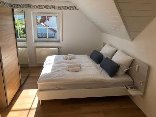 a bedroom with a bed with two pillows on it at Apartment-Regner in Weidenberg