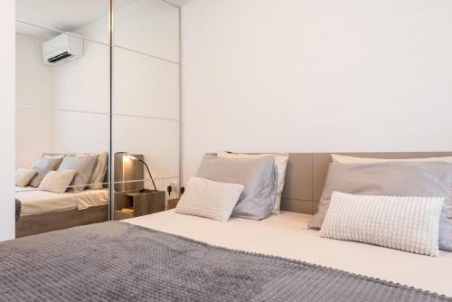 a bedroom with mirrored walls and a bed with pillows at Apartment A - Lifestyle Holiday in St. St. Constantine and Helena