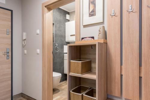 a bathroom with a wooden cabinet with a toilet at Apartment A - Lifestyle Holiday in St. St. Constantine and Helena