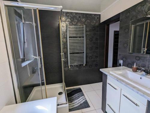 y baño con ducha y lavamanos. en Guest House close to Molo Resort, en Osiek