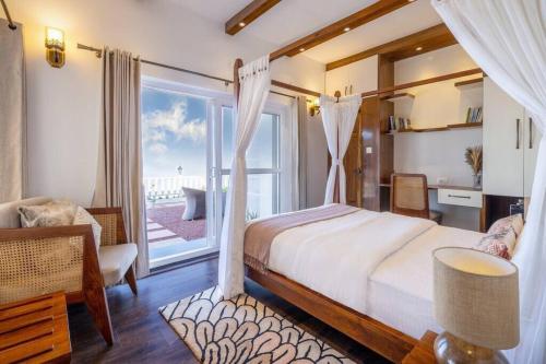 a bedroom with a bed and a large window at A Luxurious Mountain Bungalow with stunning views in Dhanaulti