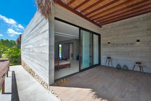 an external view of a house with a large window at Bahay Tatu in Pôrto de Pedras
