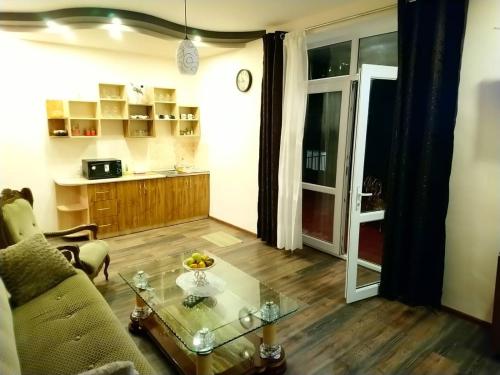 a living room with a couch and a glass table at ApartHotel in Alaverdi in Alaverdi