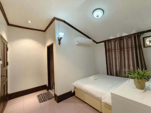 a hotel room with a bed and a window at ksana guesthouse in Luang Prabang