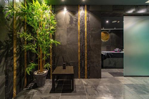 a bathroom with plants on the wall and a table at Sierra Blanca Resort and Spa in Marbella