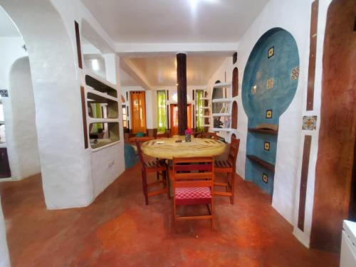 a dining room with a wooden table and chairs at Reef View Pavilions - Villas & Condos in Lance aux Épines