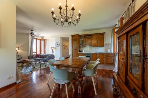 a dining room with a table and chairs at Villa Degli Olivi is located in Saragano in Saragano