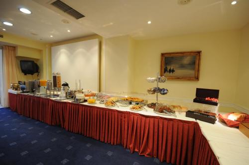 a long table with food on it in a room at Paliria Hotel in Chalkida