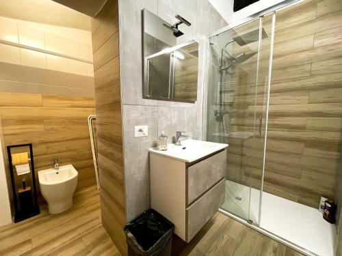 a bathroom with a sink and a shower at LE TORRI Loft Apartment in Fossano