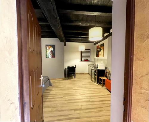 a hallway with a room with a desk and a table at LE TORRI Loft Apartment in Fossano