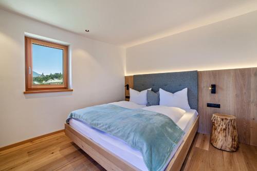 a bedroom with a large bed and a window at Huetterhof Apartement Langes in Caines