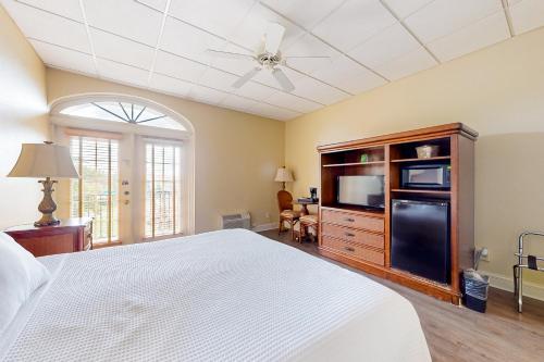 a bedroom with a bed and a dresser with a tv at Port of the Islands M252 in Naples