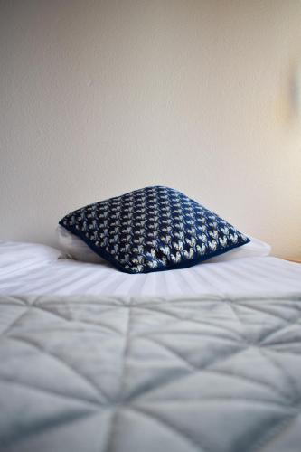 a blue pillow sitting on top of a bed at Hótel Skálholt in Golden Circle in Skálholt