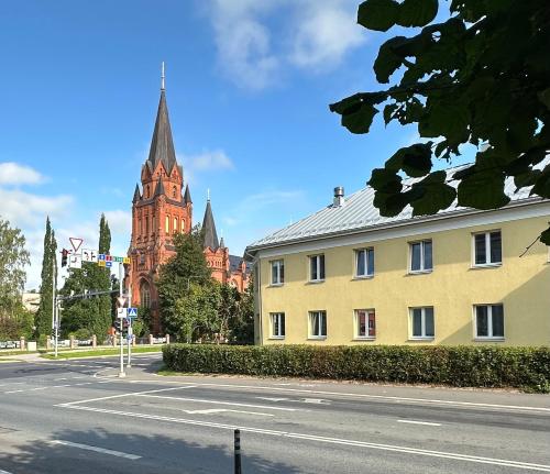 a building with a clock tower and a church at Apartment in City Center in Tartu