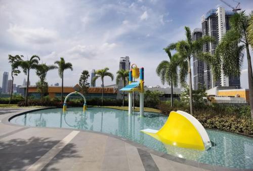 a pool with a slide and a water park at TRION KL by JRLodge Homestay in Kuala Lumpur