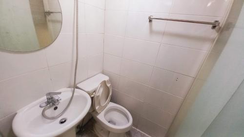 a bathroom with a sink and a toilet and a mirror at Haechi Stay GuestHouse - For foreigners only in Seoul