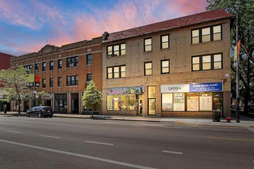 a building on a city street with a car parked in front at 3BR Spacious Apartment with In-Unit Laundry - Kedzie 3F in Chicago