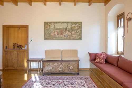 a living room with a couch and a table at Clio's Stone House in Kipoi