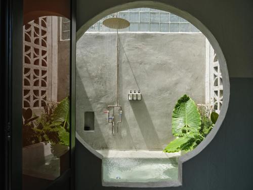 a view of a bathroom through a circular window at VERDE by DW in San Juan