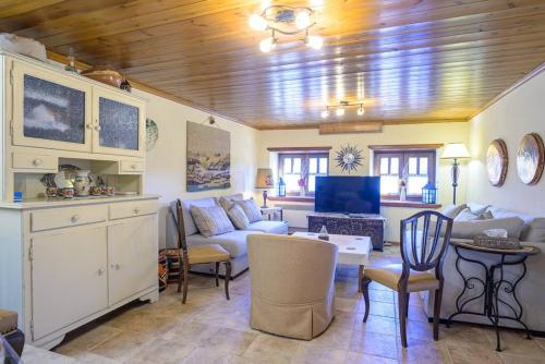 a living room with a couch and a table at Clio's Stone House in Kipoi