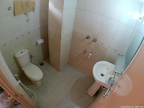a bathroom with a toilet and a sink at Hotel Surma Residential in Dhaka