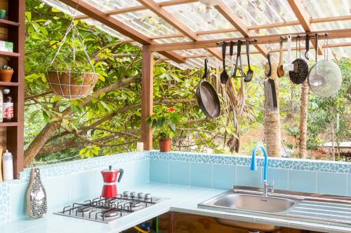 a kitchen with a sink and a wooden pergola at The Fort Hostel in Don Diego