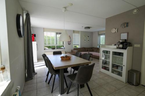 a kitchen and living room with a table and chairs at Kustverhuur, Park Schoneveld, Stern 254 in Breskens