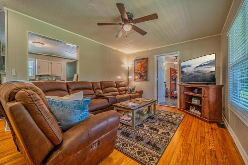 a living room with a couch and a ceiling fan at Charming Family Lakeview Cottage 3 min to lake in Dandridge