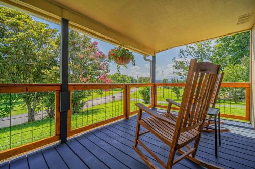 a rocking chair on a porch with a view at Charming Family Lakeview Cottage 3 min to lake in Dandridge
