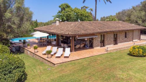 a house with a patio and a swimming pool at Villa Casa Del Talaiot Sencelles in Sencelles