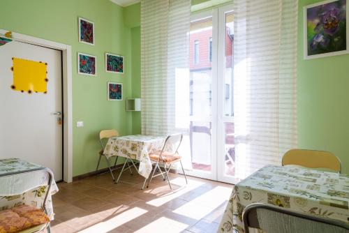 a room with two beds and a table and a window at Dacia di Bergamo in Bergamo