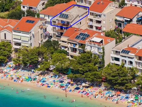 an aerial view of a beach with umbrellas and people at Apartments JD in Tučepi