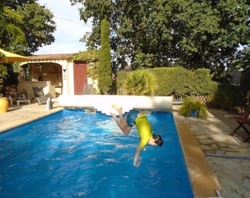 un hombre está buceando en una piscina en La Soleillade Laudun, en Laudun