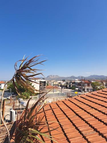a tile roof with a view of a city at Alfa Loft (by Lemon Tree Houses) in Vrahati