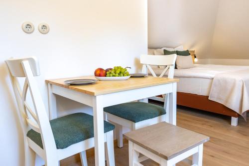 a room with a table with a bowl of fruit on it at Czakó Bed&Breakfast in Budapest