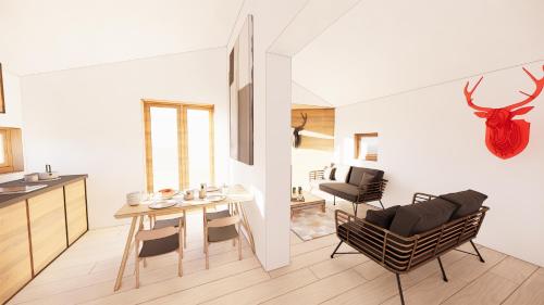 a kitchen and a living room with a table and chairs at ALPINA LODGE VANOISE ex hotel du soleil in Aussois